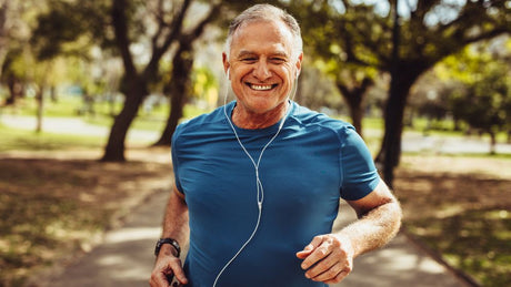 A 60 year old man happy running for exercise and keeping fit