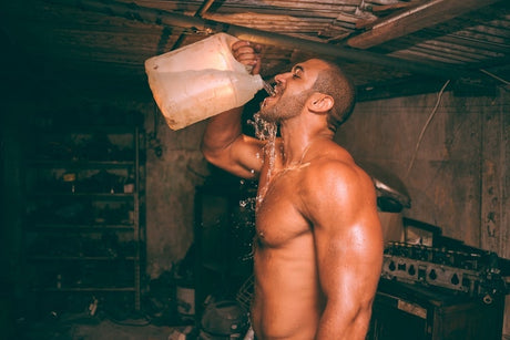 Man drinking water while working out
