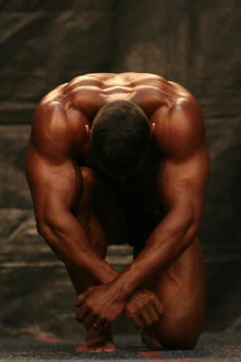 Ripped man bending over showing is back muscles