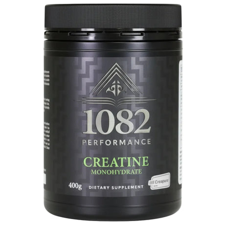 Black supplement container labeled '1082 Performance Creatine Monohydrate' on a white background