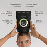 Person holding a bag of Beauty Matcha tea with text highlighting its benefits on a white background